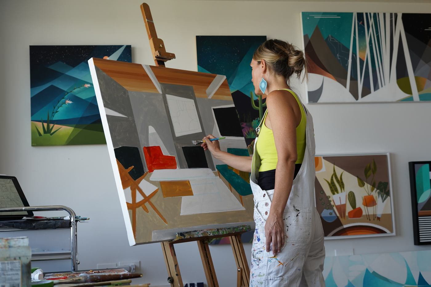 A painter working on a large canvas in her studio